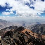 Hiker overlooking the Atlas Mountains in Morocco during a trekking adventure