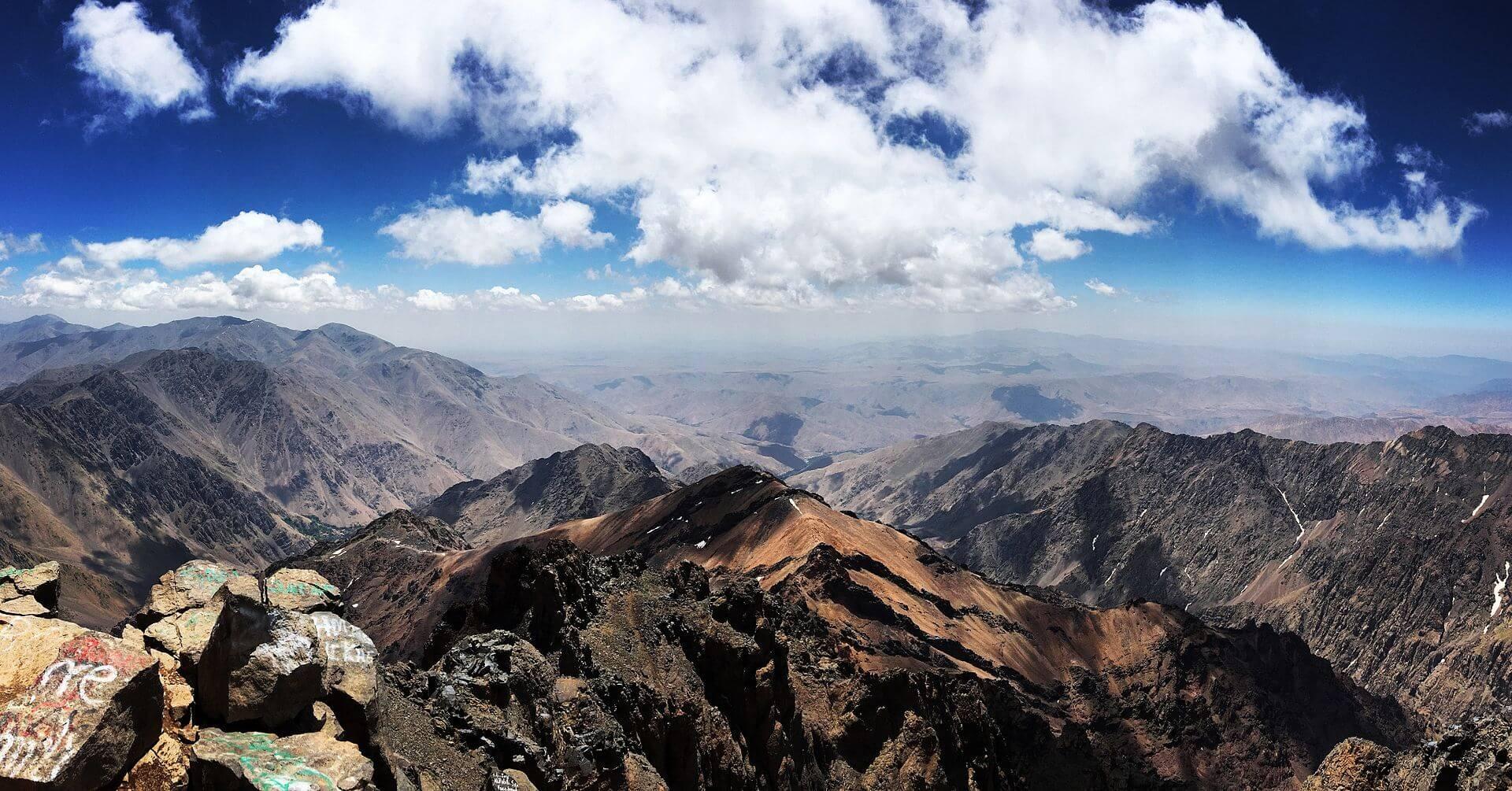 Hiker overlooking the Atlas Mountains in Morocco during a trekking adventure